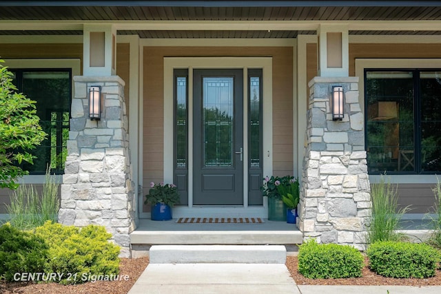 2985 E Iron Woods Pass, Midland, MI 48642 - view of exterior entry with stone siding and covered porch