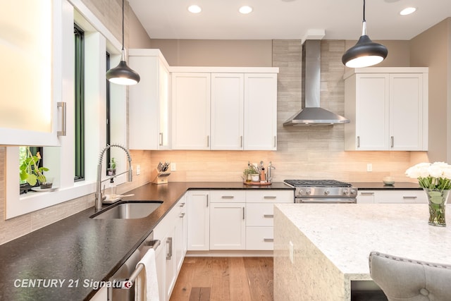 2985 E Iron Woods Pass, Midland, MI 48642 - kitchen featuring wall chimney range hood, recessed lighting, tasteful backsplash, stainless steel appliances, and white cabinets