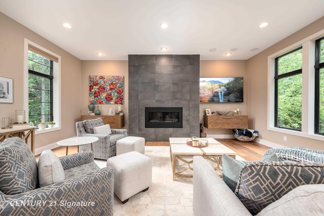 2985 E Iron Woods Pass, Midland, MI 48642 - living room with wood finished floors, recessed lighting, and a tile fireplace