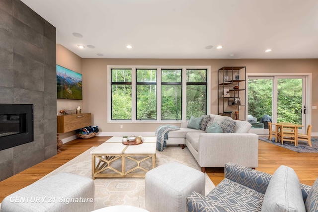 2985 E Iron Woods Pass, Midland, MI 48642 - living area with wood finished floors, plenty of natural light, recessed lighting, and a tile fireplace