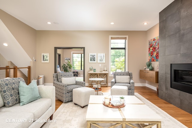 2985 E Iron Woods Pass, Midland, MI 48642 - living area with light wood finished floors, healthy amount of natural light, a fireplace, and recessed lighting