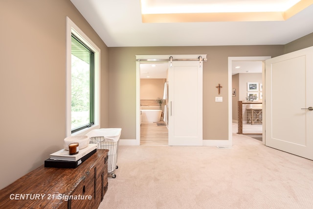 2985 E Iron Woods Pass, Midland, MI 48642 - bedroom with light carpet, a barn door, and connected bathroom