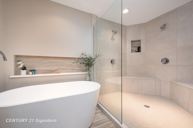 2985 E Iron Woods Pass, Midland, MI 48642 - bathroom featuring a soaking tub, a tile shower, and recessed lighting