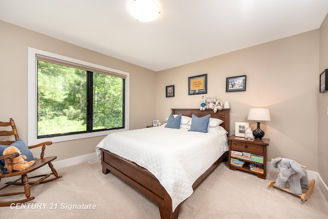 2985 E Iron Woods Pass, Midland, MI 48642 - bedroom featuring light carpet and baseboards