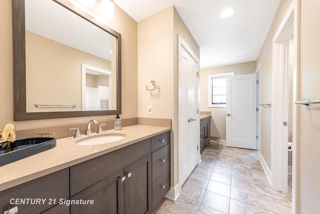 2985 E Iron Woods Pass, Midland, MI 48642 - bathroom featuring vanity and marble finish floors