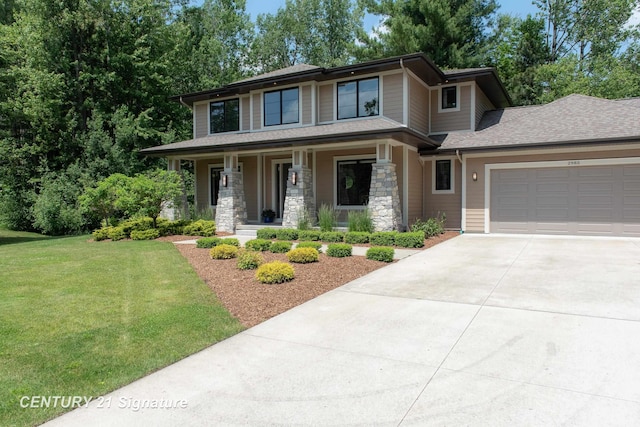 2985 E Iron Woods Pass, Midland, MI 48642 - prairie-style house featuring a porch, driveway, an attached garage, a front yard, and a shingled roof