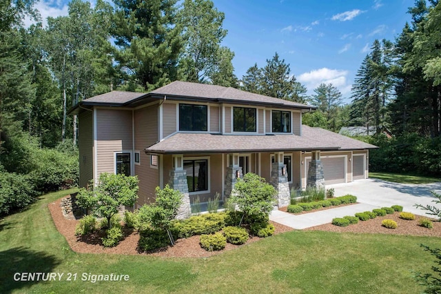 2985 E Iron Woods Pass, Midland, MI 48642 - view of front of home with an attached garage, covered porch, concrete driveway, and a front lawn