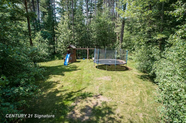2985 E Iron Woods Pass, Midland, MI 48642 - view of green lawn with a playground and a trampoline