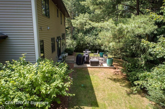2985 E Iron Woods Pass, Midland, MI 48642 - view of grassy yard with a patio area