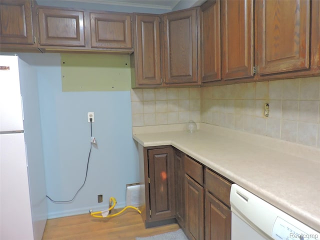 239 W Cornell Ave, Pontiac, MI 48340 - kitchen with white appliances, light countertops, tasteful backsplash, and light wood finished floors
