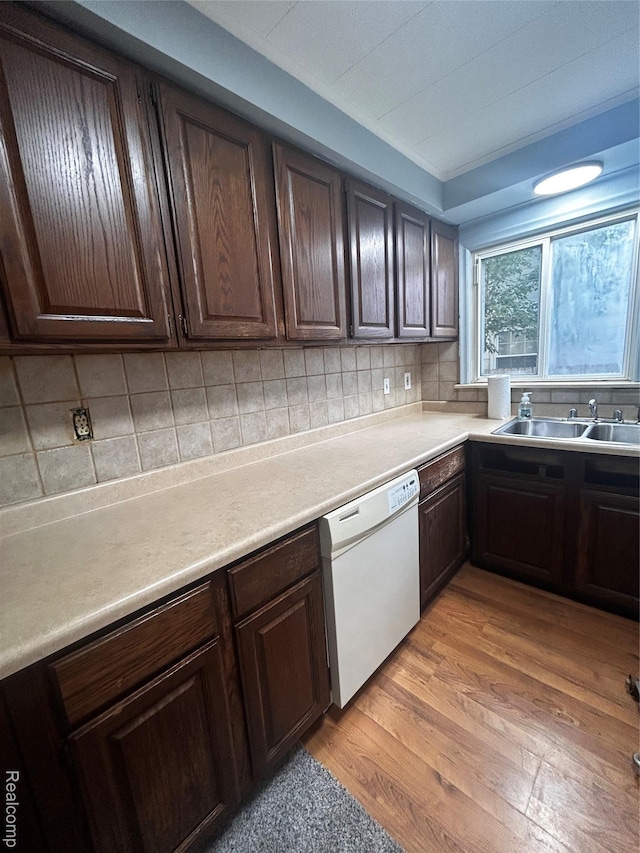 239 W Cornell Ave, Pontiac, MI 48340 - kitchen featuring white dishwasher, light wood-style floors, dark brown cabinets, and tasteful backsplash