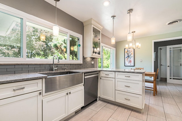 2507 Riverwood Ter, Saint Joseph, MI 49085 - kitchen featuring dishwasher, decorative backsplash, a peninsula, light stone countertops, and glass insert cabinets