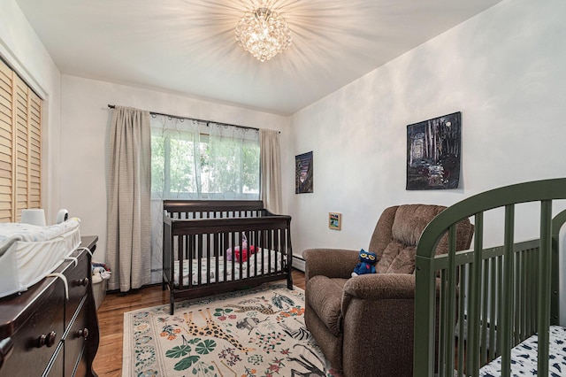 2507 Riverwood Ter, Saint Joseph, MI 49085 - bedroom featuring wood finished floors and a chandelier