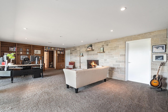 2507 Riverwood Ter, Saint Joseph, MI 49085 - carpeted living area featuring a stone fireplace, recessed lighting, and a desk