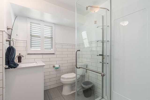 2507 Riverwood Ter, Saint Joseph, MI 49085 - full bathroom with tile walls, vanity, tile patterned floors, and a stall shower