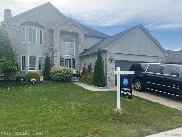 36339 Cecilia Dr, Sterling Heights, MI 48312 - traditional home with an attached garage, brick siding, and a front lawn