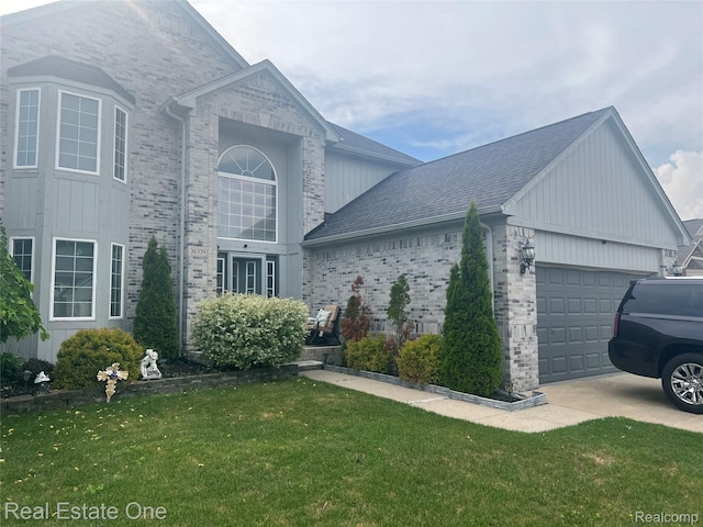 36339 Cecilia Dr, Sterling Heights, MI 48312 - view of side of home with a garage, a lawn, driveway, and brick siding