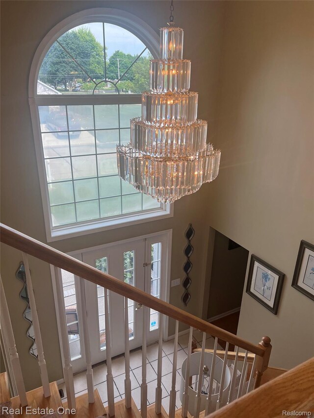 36339 Cecilia Dr, Sterling Heights, MI 48312 - stairway featuring a chandelier, plenty of natural light, and a towering ceiling
