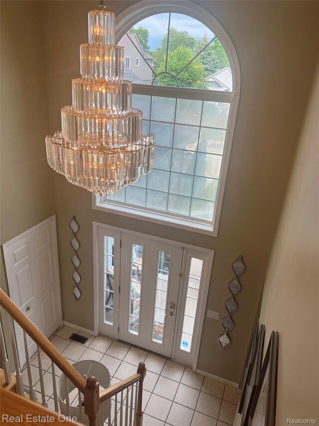 36339 Cecilia Dr, Sterling Heights, MI 48312 - foyer featuring a chandelier, a high ceiling, light tile patterned floors, and stairs