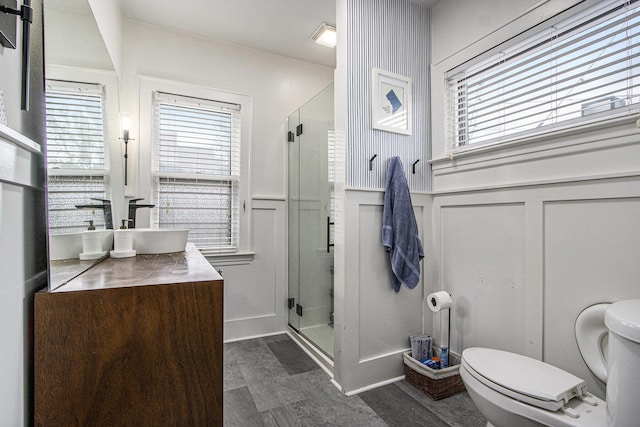 2313 S Westnedge Ave, Kalamazoo, MI 49008 - full bathroom with a decorative wall, vanity, a shower stall, wainscoting, and plenty of natural light