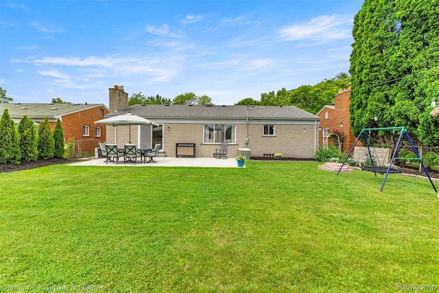 17276 Midway Ave, Allen Park, MI 48101 - back of house with a patio, brick siding, a playground, and a chimney