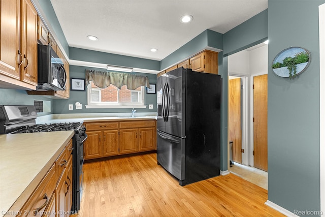 17276 Midway Ave, Allen Park, MI 48101 - kitchen with stainless steel appliances, light countertops, light wood-type flooring, brown cabinets, and recessed lighting