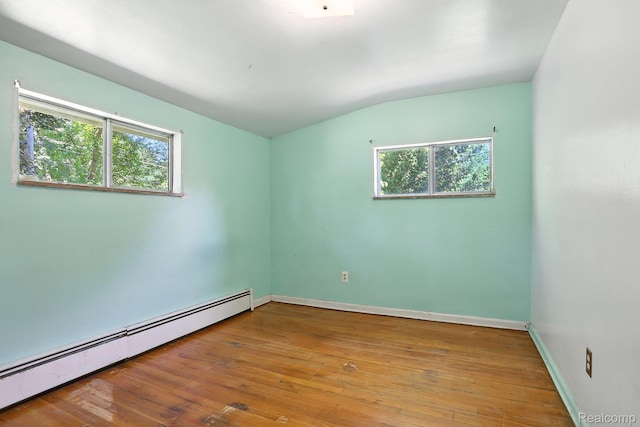 45411 Sterritt St, Utica, MI 48317 - unfurnished room featuring baseboard heating, plenty of natural light, vaulted ceiling, and wood-type flooring