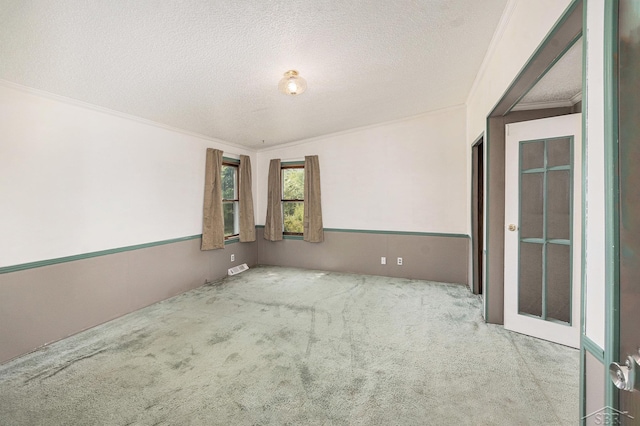 11816 Morton Rd, Manistee, MI 49660 - spare room with carpet floors, a textured ceiling, and ornamental molding