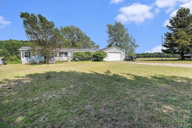 11816 Morton Rd, Manistee, MI 49660 - ranch-style house with driveway, a front lawn, and an attached garage