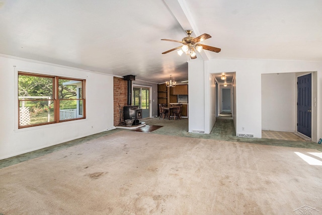 11816 Morton Rd, Manistee, MI 49660 - unfurnished living room with a wood stove, carpet, a ceiling fan, and a chandelier