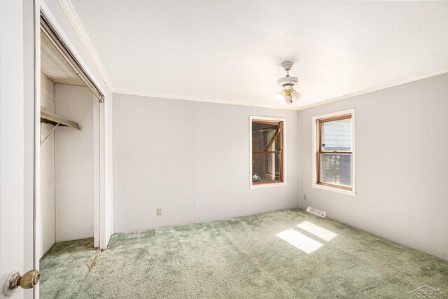 11816 Morton Rd, Manistee, MI 49660 - unfurnished bedroom featuring carpet floors, ornamental molding, and a ceiling fan