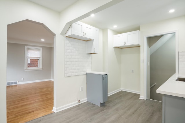 9250 Rosedale Blvd, Allen Park, MI 48101 - kitchen featuring light wood finished floors, white cabinetry, light countertops, recessed lighting, and decorative backsplash