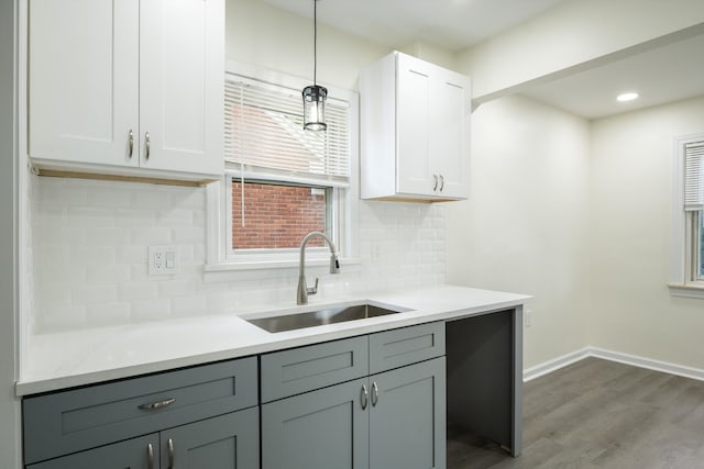 9250 Rosedale Blvd, Allen Park, MI 48101 - kitchen featuring wood finished floors, tasteful backsplash, light countertops, decorative light fixtures, and white cabinetry