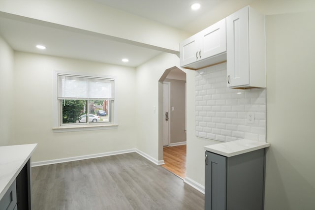 9250 Rosedale Blvd, Allen Park, MI 48101 - kitchen with arched walkways, tasteful backsplash, wood finished floors, white cabinetry, and recessed lighting