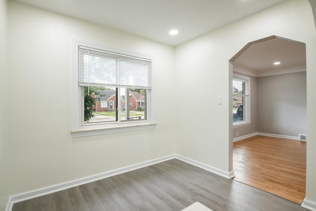 9250 Rosedale Blvd, Allen Park, MI 48101 - empty room with wood finished floors, arched walkways, and recessed lighting