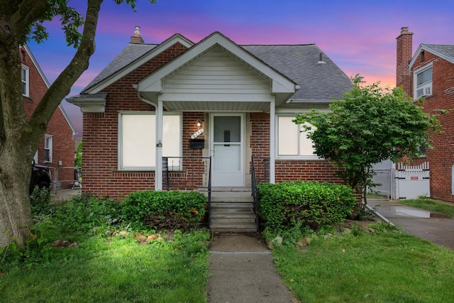 9250 Rosedale Blvd, Allen Park, MI 48101 - bungalow featuring brick siding, a shingled roof, and a gate