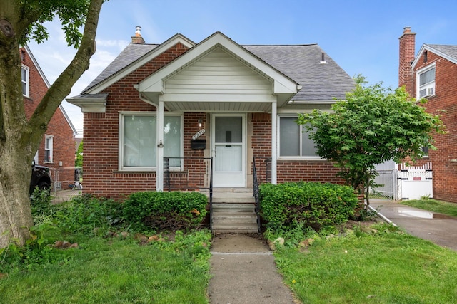 9250 Rosedale Blvd, Allen Park, MI 48101 - bungalow-style house featuring brick siding, a shingled roof, and a gate