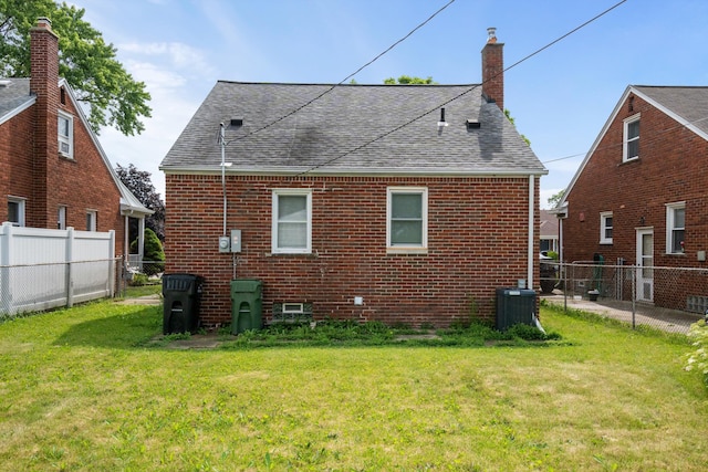 9250 Rosedale Blvd, Allen Park, MI 48101 - back of property featuring a shingled roof, brick siding, a fenced backyard, and a chimney