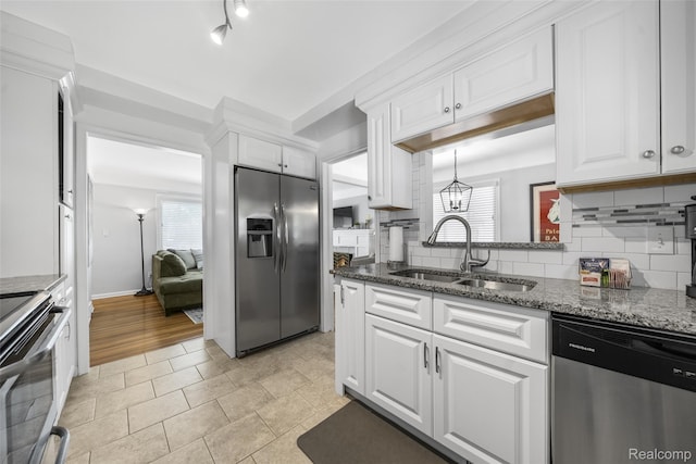 2195 Pembroke Rd, Birmingham, MI 48009 - kitchen with stainless steel appliances, white cabinets, tasteful backsplash, and dark stone counters