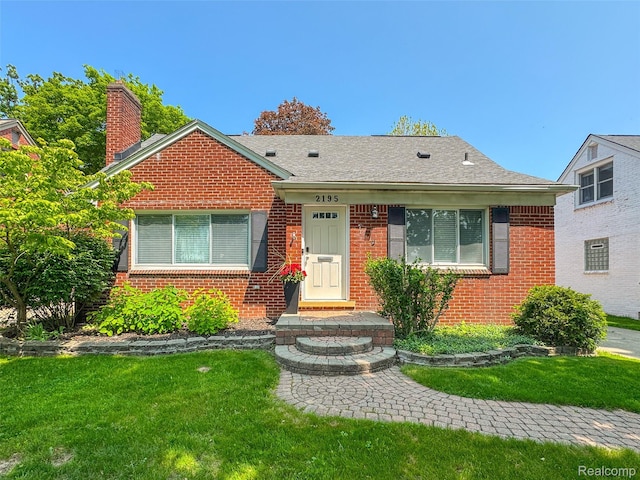2195 Pembroke Rd, Birmingham, MI 48009 - bungalow-style home featuring brick siding, a front yard, and a chimney