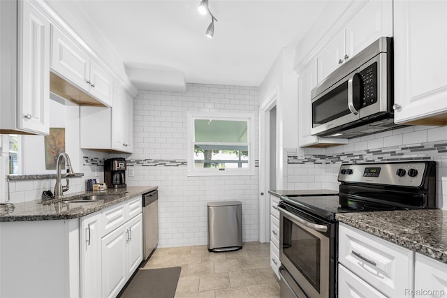 2195 Pembroke Rd, Birmingham, MI 48009 - kitchen featuring appliances with stainless steel finishes, white cabinetry, dark stone counters, and decorative backsplash