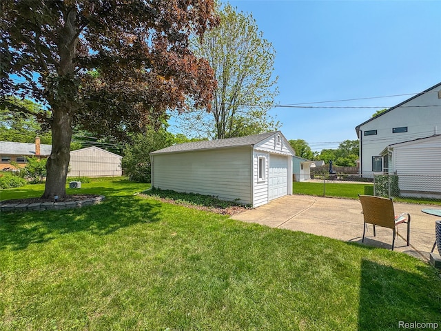 2195 Pembroke Rd, Birmingham, MI 48009 - view of yard with a garage, an outbuilding, and a patio