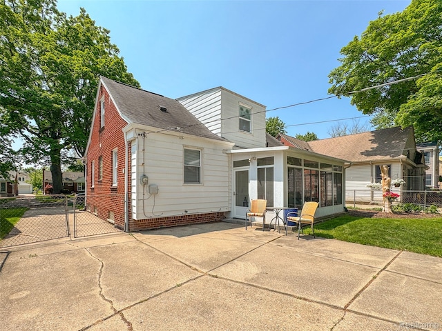 2195 Pembroke Rd, Birmingham, MI 48009 - back of house with a sunroom, a patio, roof with shingles, and a gate