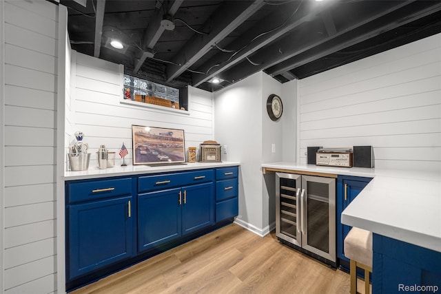 2195 Pembroke Rd, Birmingham, MI 48009 - indoor dry bar featuring wine cooler, wood walls, and light wood-type flooring