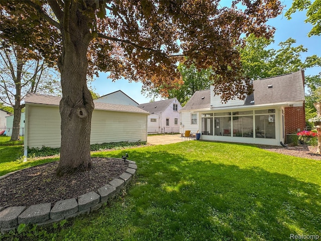2195 Pembroke Rd, Birmingham, MI 48009 - rear view of property with a sunroom, a patio area, and roof with shingles