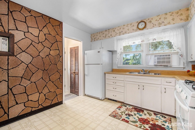 3156 Tuell St NW, Grand Rapids, MI 49504 - kitchen with white appliances, light countertops, white cabinets, light floors, and wallpapered walls