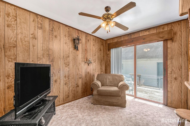 3156 Tuell St NW, Grand Rapids, MI 49504 - sitting room featuring wood walls, ceiling fan, and carpet floors