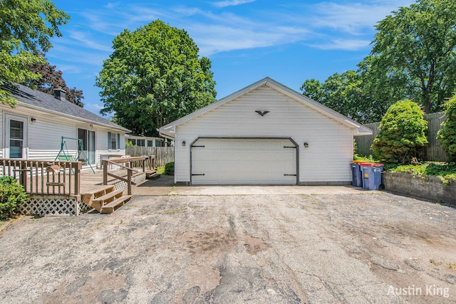 3156 Tuell St NW, Grand Rapids, MI 49504 - view of front of property with a detached garage, a deck, and an outbuilding