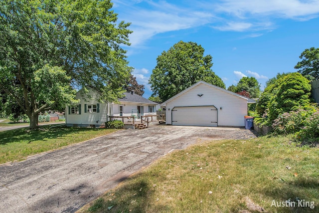 3156 Tuell St NW, Grand Rapids, MI 49504 - view of front of home with an outbuilding, a garage, a front lawn, and a deck