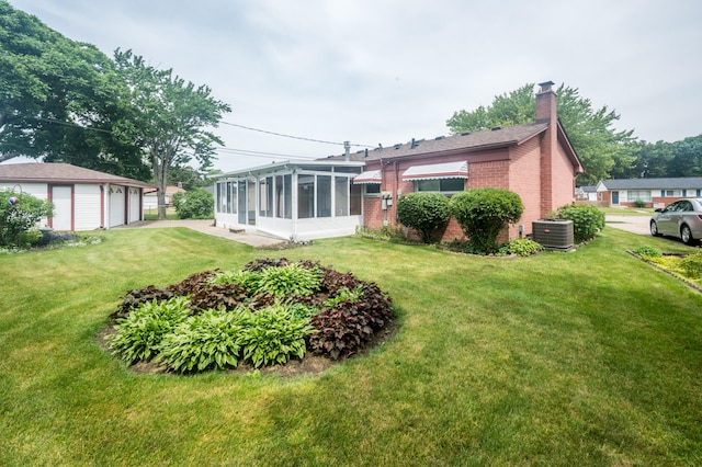 36067 Rolf St, Westland, MI 48186 - rear view of house with a sunroom, a garage, a chimney, brick siding, and a yard